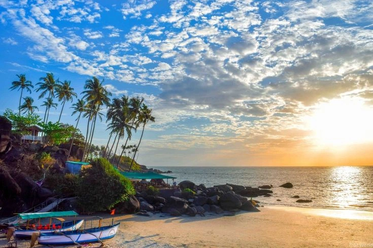 Quiet beach in Goa during the summer season with clear skies, calm sea, and fewer visitors
